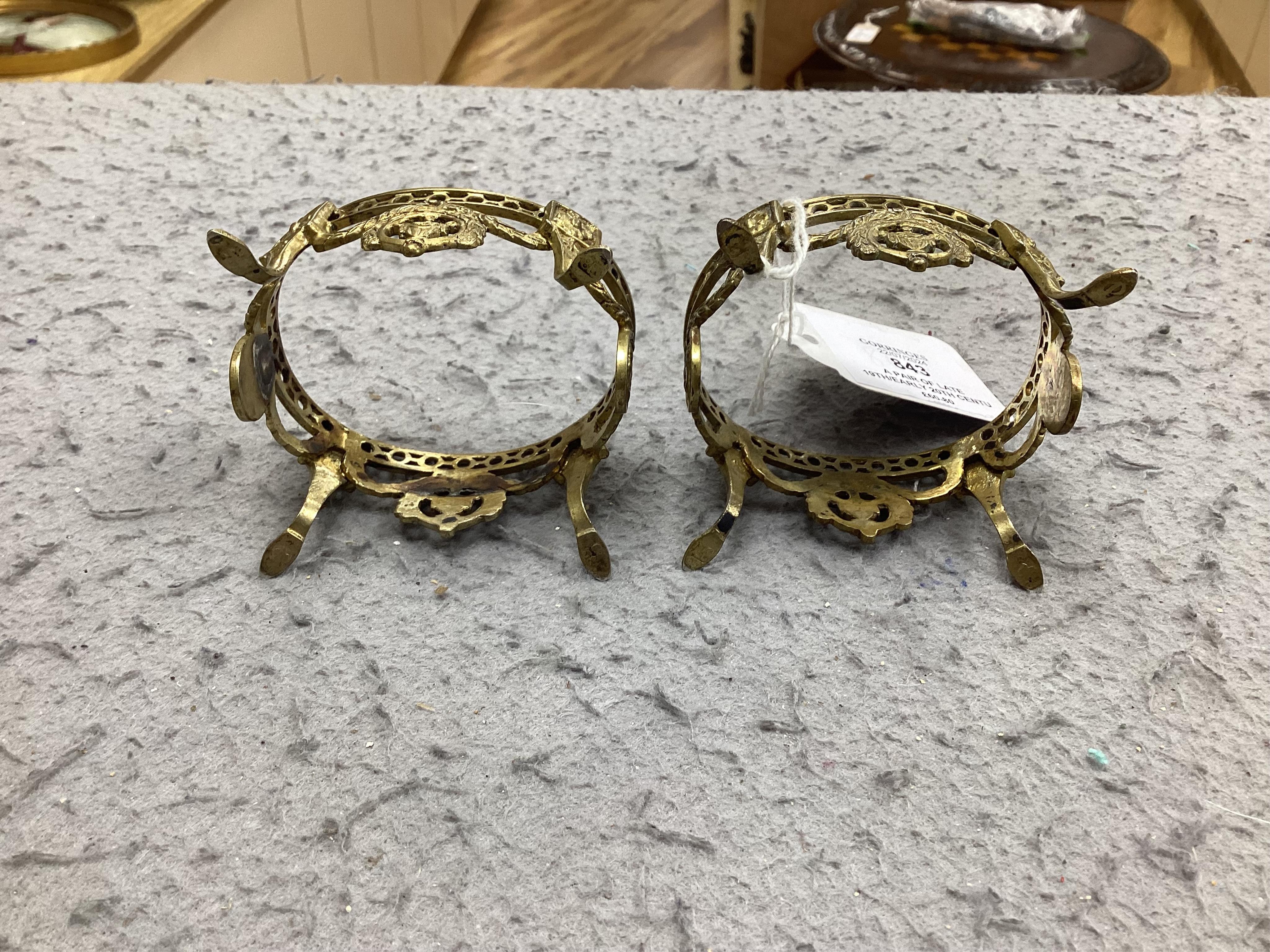 A pair of late 19th/early 20th century continental pierced gilt white metal oval salts, with blue glass liners, 69mm. Condition - fair